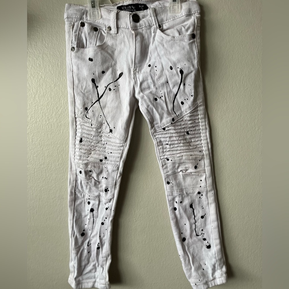 Boys White jeans with black splash pattern.